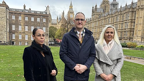 Ian Sollom with two members of impacted families