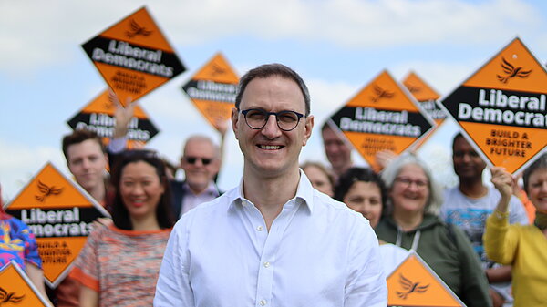 Ian Sollom with volunteers in the background
