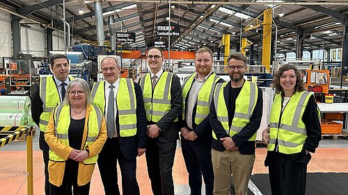 Group shot of the visitors to the Miers Factory